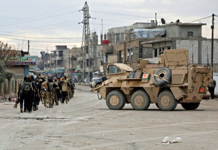 A vehicle of the US-led coalition takes up position on the streets of Hasakeh