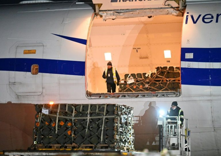 Employees unload a plane carrying new US security assistance provided to Ukraine, at Kyiv's airport Boryspil airport
