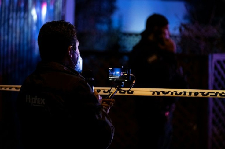 Media workers cover the crime scene where journalist Lourdes Maldonado was murdered in Tijuana, Mexico