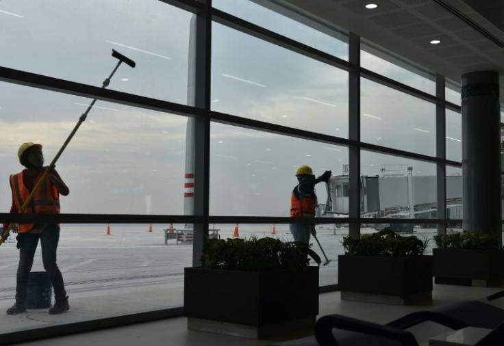 Workers clean the windows of the  passenger terminal at Mexico City's new international airport, which is due to open on March 21