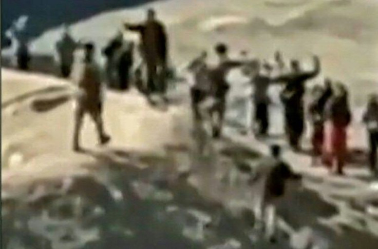An image grab taken from a video posted online by the Syrian Democratic Forces on January 24, 2022, reportedly shows Islamic State group detainees surrendering to SDF fighters outside Ghwayran prison