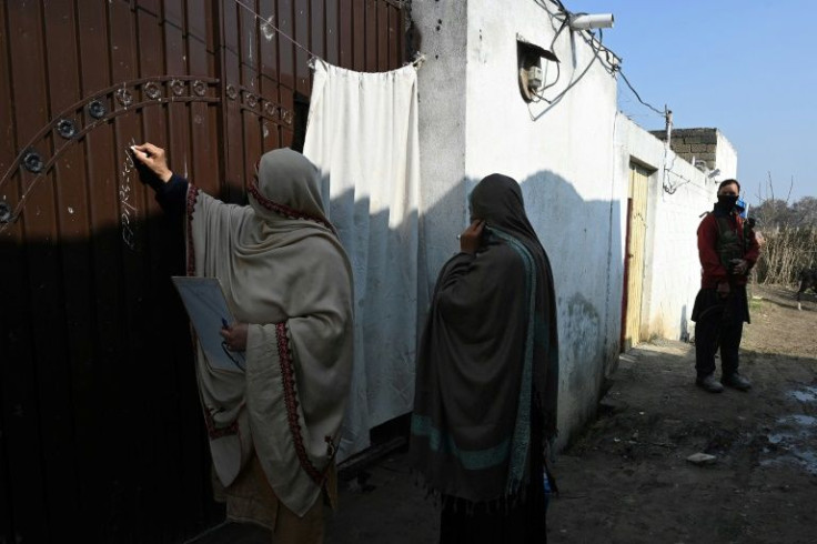 The anti-polio teams chalk dates on the homes they visit and smear children's fingers with indelible ink to mark those already inoculated