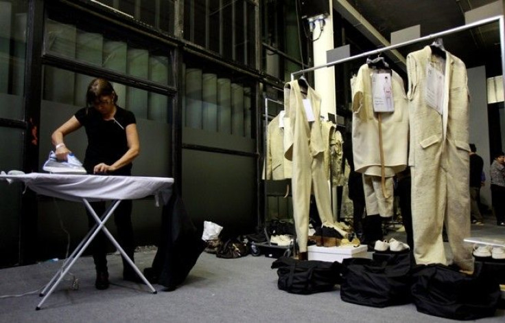 A woman iron clothes from Osklen's Summer 2012 collection during Sao Paulo Fashion week in Sao Paulo 