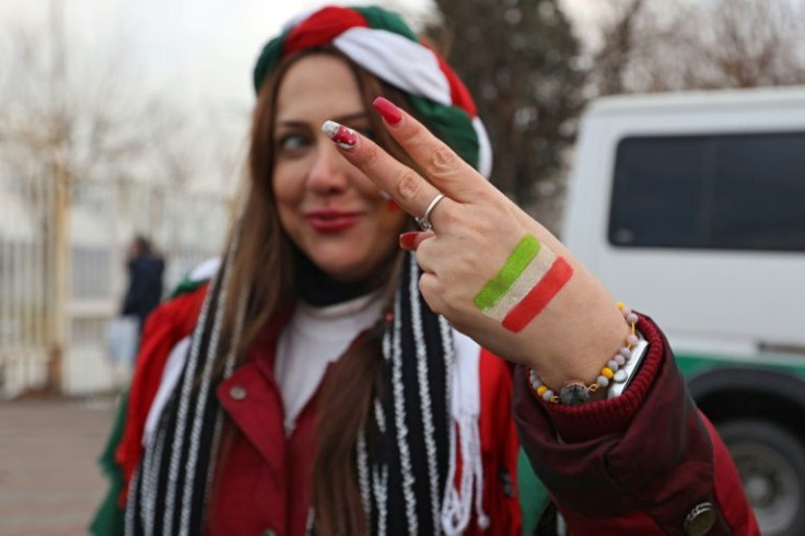 An Iranian female football fan poses ahead of the 2022 Qatar World Cup Asian Qualifiers match against Iraq, the first time in three years women were allowed to attend a national team match