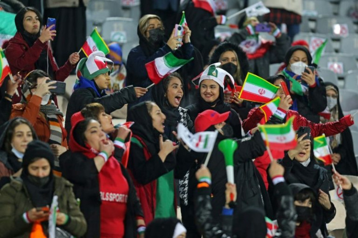 Female Iranian supporters cheer their national team for the first time in almost three years, at a Tehran stadium