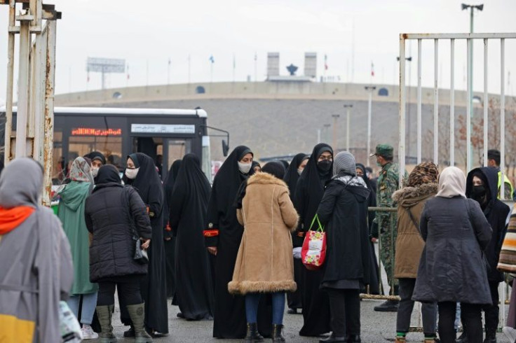 Female fans entered through a special stadium entrance, guarded by black-clad officers