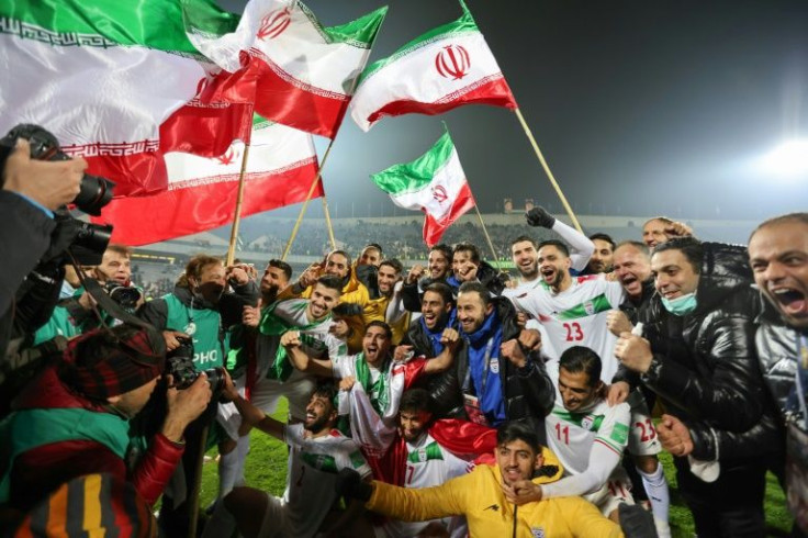 Iran's players celebrate with fans after qualifying for the 2022 Qatar World Cup finals in Qatar.
