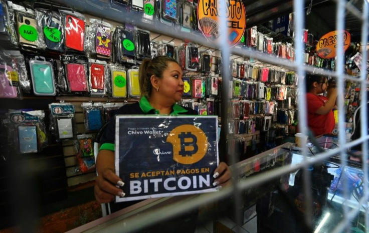 A San Salvador shopkeeper displays a sign indicating that the store accepts bitcoin