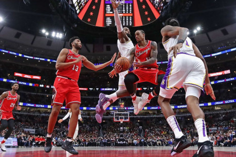  DeMar DeRozan #11 of the Chicago Bulls passes to teammate Tony Bradley #13 under pressure from LeBron James #6 (rear) and DeAndre Jordan #10 of the Los Angeles Lakers 