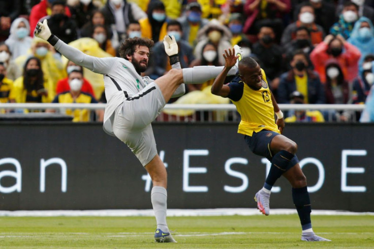 Alisson Becker of Brazil collides with Enner Valencia of Ecuador