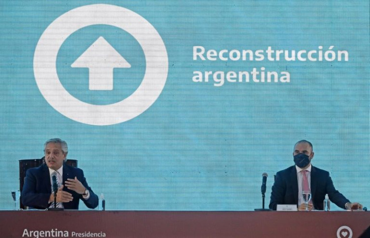 Argentine President Alberto Fernandez (L) and Economy Minister Martin Guzman speak about the proposed debt restructuring with the International Monetary Fund during a government meeting on January 5, 2022 in Buenos Aires