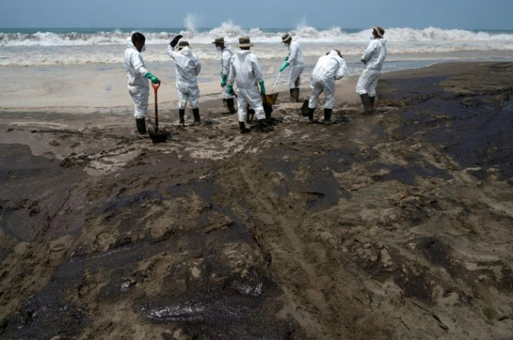 Peruvian soldiers help clean up one of around 20 beaches affected by the oil spill blamed on Spanish energy giant Repsol