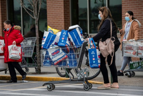 People push carts full of groceries out of a supermarket in Lynn, Massachusetts on January 28, 2022 as they prepare for the coming blizzard