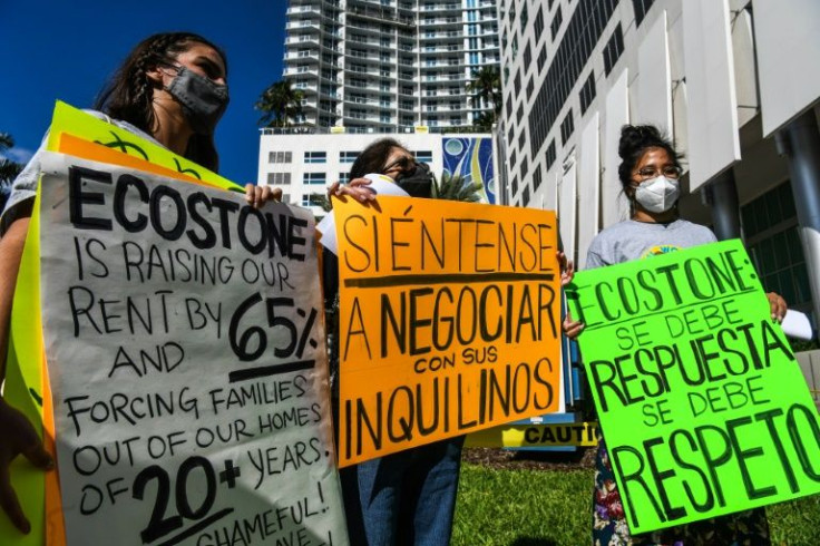 Maria Ruby (C) and others protest outside the Eco Stone Group's office building in Miami, Florida on January 19, 2022