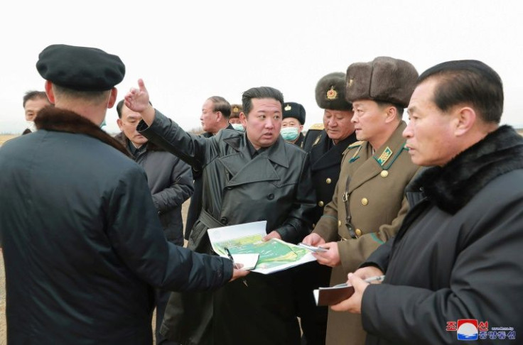 North Korea has doubled-down on leader Kim Jong Un's (C) vow to modernise the regime's armed forces, flexing Pyongyang's military muscles despite international sanctions