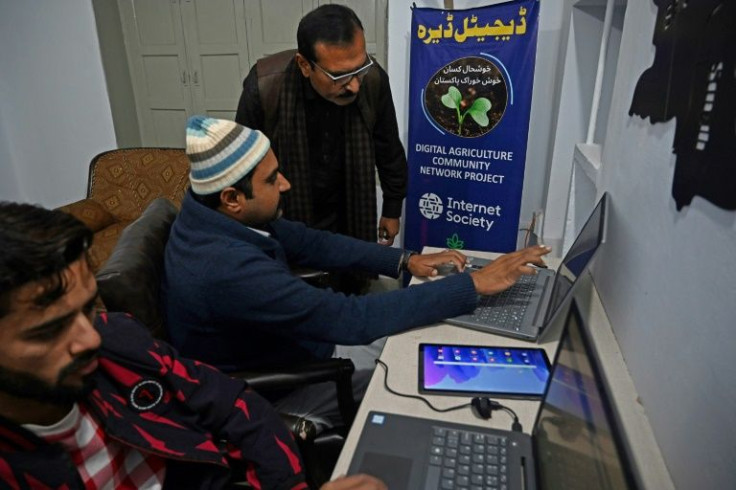 Aamer Hayat Bhandara (C), a farmer and local councillor, hopes digital tools will revolutionise Pakistan's agriculture industry