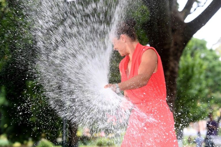 Ashleigh Barty sprays a bottle of champagne to celebrate