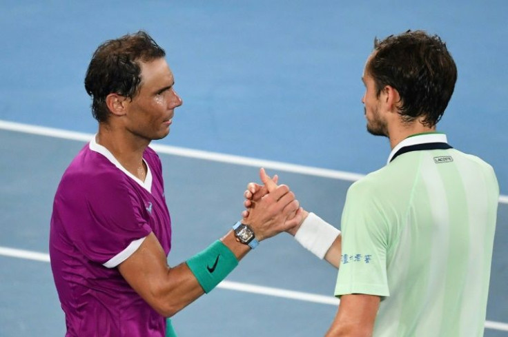 Spain's Rafael Nadal (L) shakes hands with Russia's Daniil Medvedev after winning the men's singles final match on day fourteen of the Australian Open tennis tournament in Melbourne early on January 31, 2022.