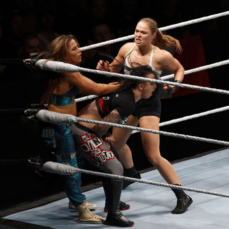 Ronda Rousey (R) in action vs Mickie James (L ) and Ruby Riott 
