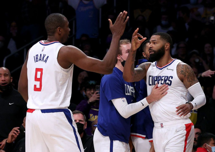 Marcus Morris Sr. #8 of the LA Clippers celebrates his three pointer with Luke Kennard #5 and Serge Ibaka #9 