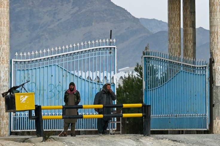 Taliban fighters stand guard at the main gate of Laghman University after classes resumed for the first time since the hardline Islamist group returned to power