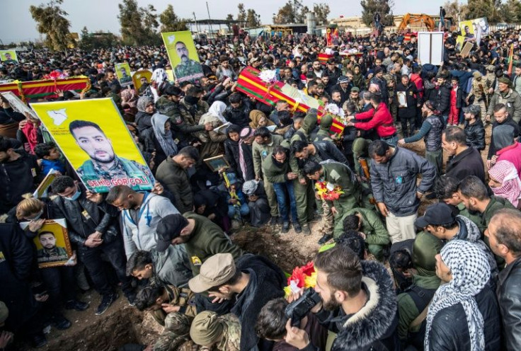 People in Syria's northeastern Hasakeh province take part in a funeral for Syrian Democratic Forces fighters in the Kurdish-majority city of Qamishli