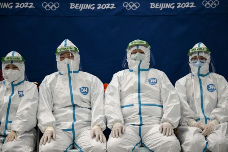 Staff wearing personal protective equipment at a medical station before a women's hockey match