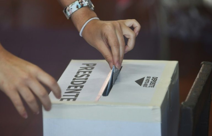 In this file photo taken in 2018, a woman casts her vote at a polling station in San Jose in 2018