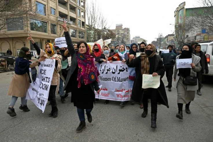 Afghan women chant slogans and hold banners during a protest in Kabul