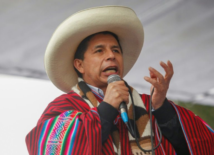 Peruvian President Pedro Castillo, dressed in typical Andean attire, speaks during a massive rally calling for political and economic stability in Juliaca, Puno region, Peru in December 2021