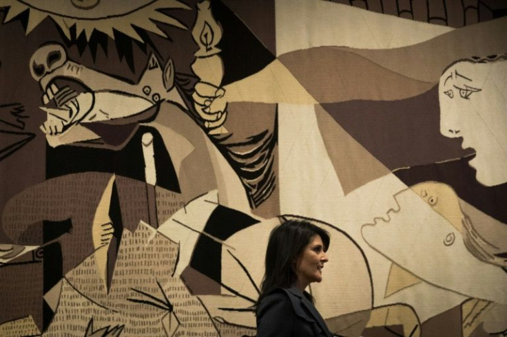 Then-US ambassador to the United Nations Nikki Haley passes before the 'Guernica' tapestry at the UN on January 2, 2018