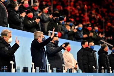 UN Secretary-General Antonio Guterres (L), International Olympic Committee (IOC) President Thomas Bach (2nd from L) and China's President Xi Jinping (3rd from L) wave during the opening ceremony of the Beijing Winter Olympics