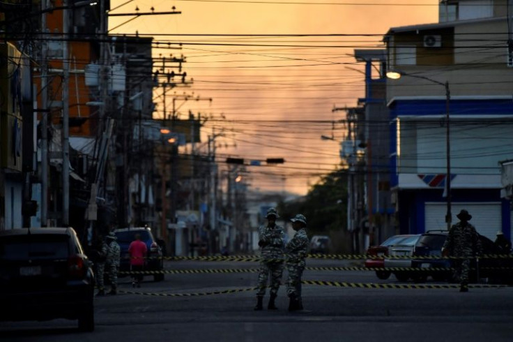 Security forces stand guard during a re-run gubernatorial election in Barinas city, Venezuela, on January 9, 2022