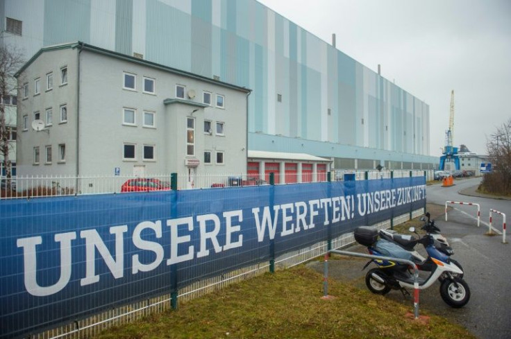 A banner reading "Our Shipyard! Our Future!" hangs at the main gate to the assembly hall of the MV Werften shipbuilder