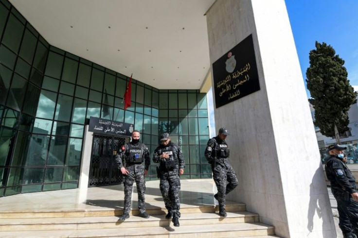 Members of the Tunisian security forces stand outside the closed entrance to the Supreme Judicial Council (CSM)