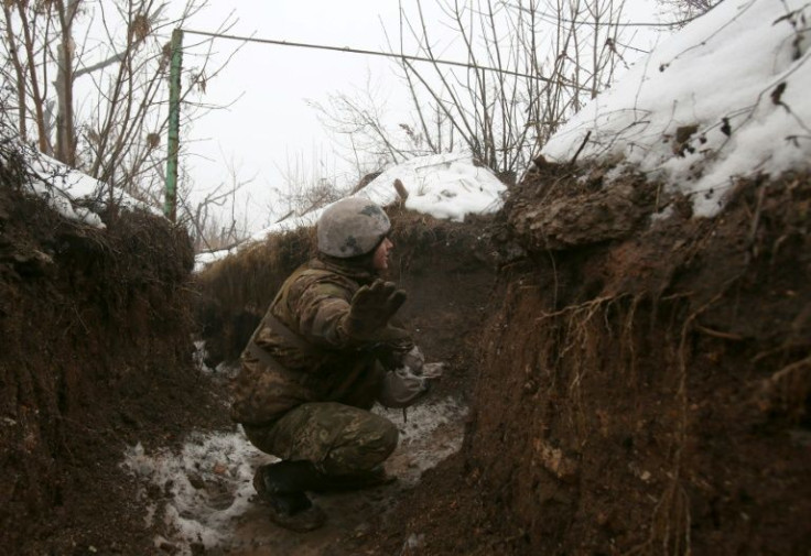 A Ukrainian serviceman patrols in a trench on the frontline against  Russia-backed separatists near Avdiivka, Donetsk region