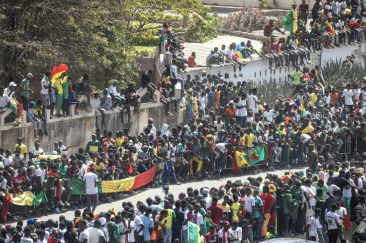 Fans crowd the roads around the Dakar airport waiting for the Senegal team to return in triumph