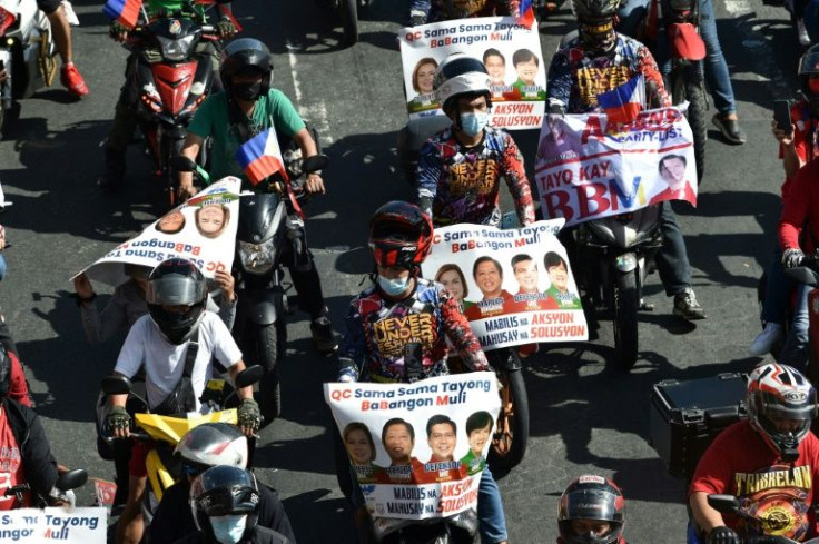 Supporters of presidential candidate Bongbong Marcos, son of the late Philippine dictator Ferdinand Marcos, ride in a motorcade along a street in Quezon City, suburban Manila