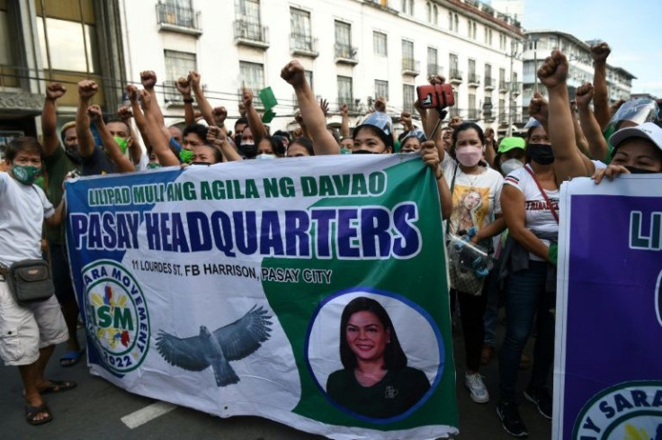 Supporters of vice-presidential candidate Sara Duterte, daughter of President Rodrigo Duterte, displaying banners with her image during a rally in front of the election commission in Manila