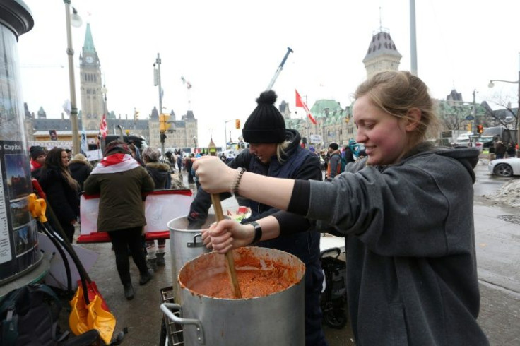 Two supporters in Ottawa prepare lunch as demonstrators continue to protest Canada's vaccine mandates