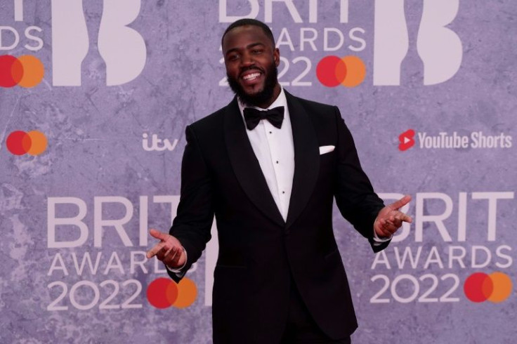 British stand-up comedian Mo Gilligan took a swipe at scandal-embroiled British Prime Minister Boris Johnson while hosting the 2022 Brit awards, inviting him to the ceremony to enjoy some cheese