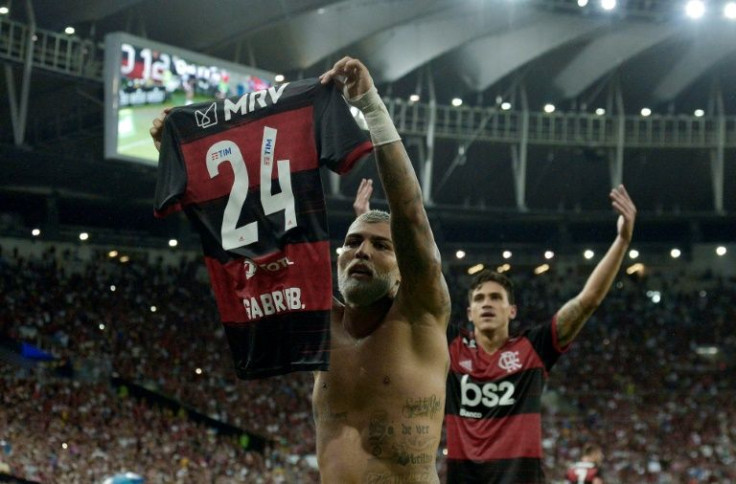 At a game in February 2020, Flamengo player Gabriel Barbosa -- known as Gabigol -- shows a jersey with the number 24 as part of a campaign against homophobia in Brazilian football