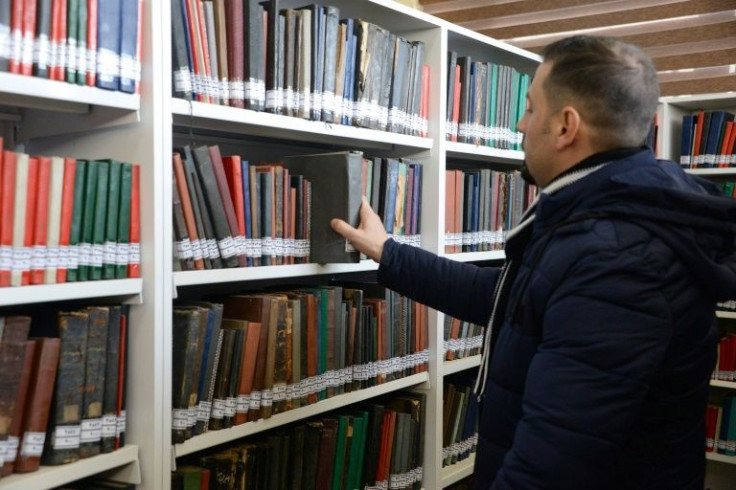 A librarian picks a book ub Mosul; almost five years after the defeat of IS, the war-battered city is trying to rebuild the library