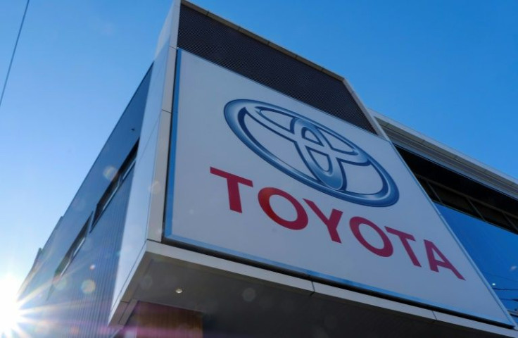A weaker yen, high demand and internal cost-cutting measures have cushioned Toyota's profits despite the production cuts