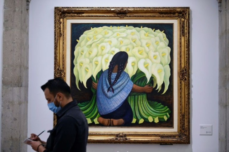 A man takes notes in front of Diego Rivera's "Vendedora de alcatraces" -- part of the Banamex collection, whose impending sale has sparked calls for the cultural treasures to stay in Mexico
