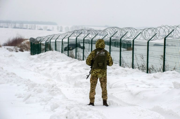 A Ukrainian border guard patrols the frontier with Russia, as tensions mount over fears Moscow could invade