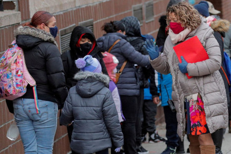 A principal greets students as they return to New York City's public schools for in-person learning, as the global outbreak of the coronavirus disease (COVID-19) continues, at P.S. 506 in Brooklyn, New York, U.S., December 7, 2020.  