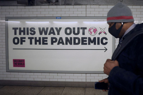 A man walks past a sign amidst the spread of the coronavirus disease (COVID-19), in London, Britain, January 24, 2022. 