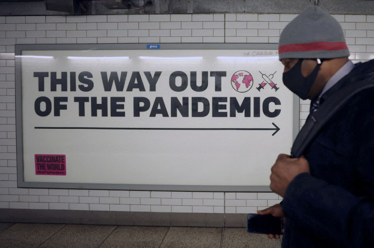 A man walks past a sign amidst the spread of the coronavirus disease (COVID-19), in London, Britain, January 24, 2022.
