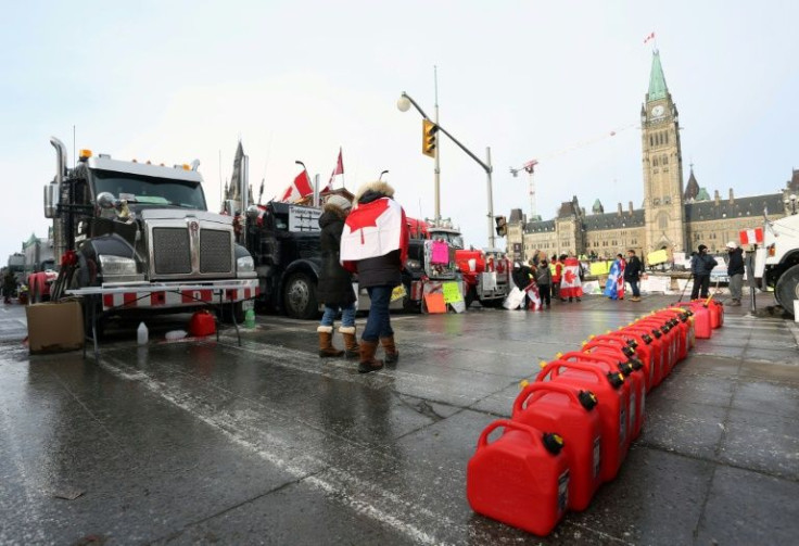 Empty jerry cans line the street in front of parked trucks as demonstrators protest the Covid-19 vaccine mandates implemented by Prime Minister Justin Trudeau in Ottawa, Canada